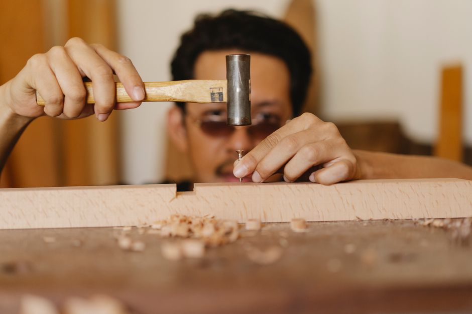 Carpenter shaping wood with a chisel